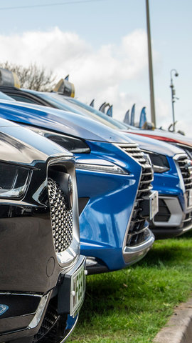Cars in a row on dealer forecourt