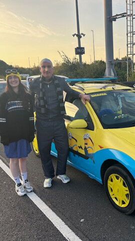 Shania and Richard driving in our minion car for Bangers4Ben