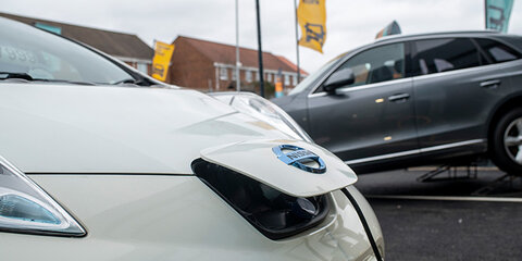 White nissan being charged - main desktop image