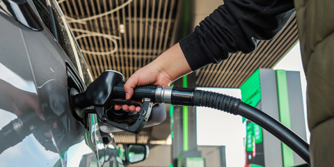 Individual filling up their car with petrol - desktop